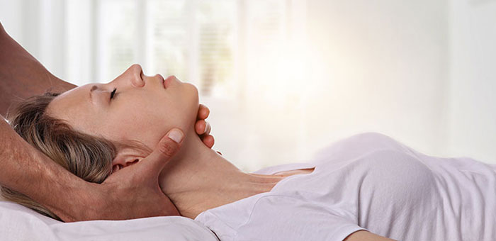 Woman receiving neck adjustment from Cleveland chiropractor